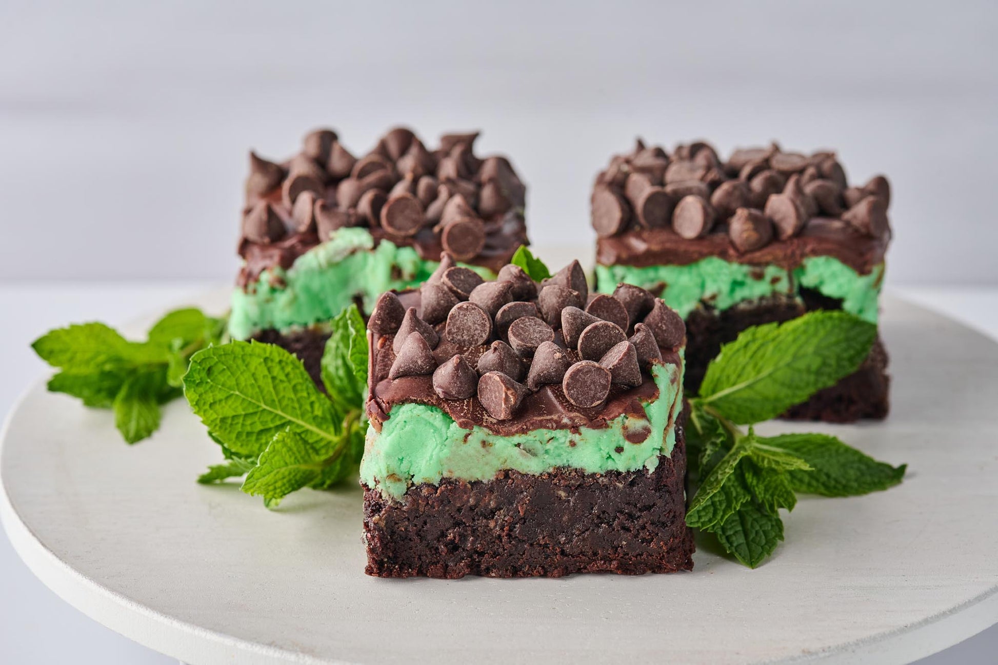 Chocolate and Mint Brownie with fudgy cocoa base, minty buttercream layer, mint-infused chocolate, and chocolate chips, offering a rich and refreshing contrast of flavors