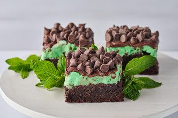 Chocolate and Mint Brownie with fudgy cocoa base, minty buttercream layer, mint-infused chocolate, and chocolate chips, offering a rich and refreshing contrast of flavors