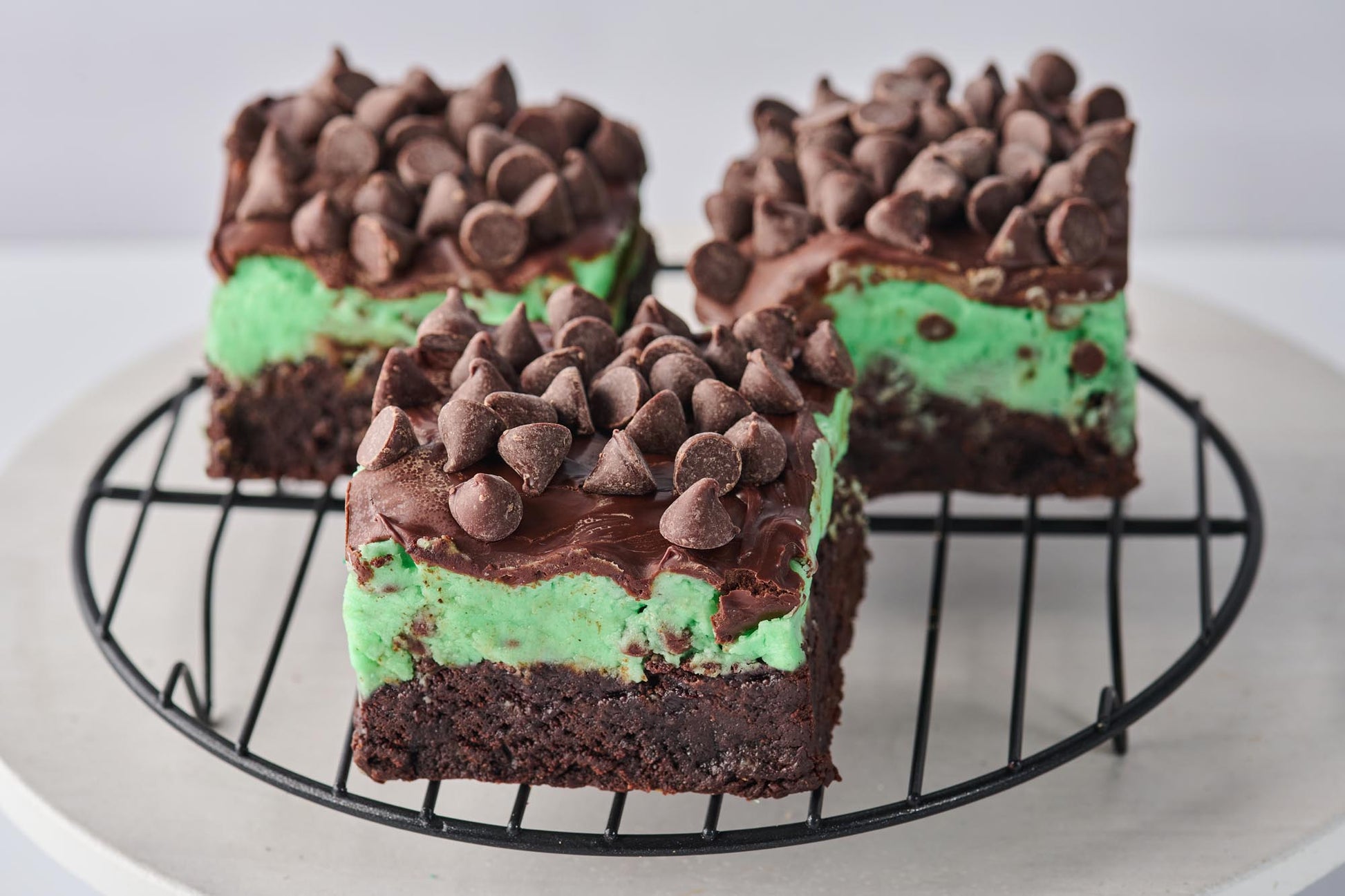 Chocolate and Mint Brownie with fudgy cocoa base, minty buttercream layer, mint-infused chocolate, and chocolate chips, offering a rich and refreshing contrast of flavors