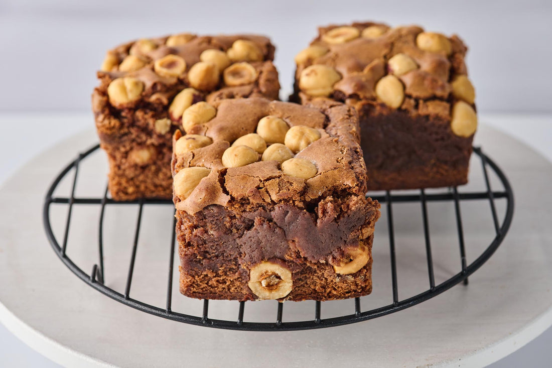 Nutella and Hazelnut Brownie with fudgy cocoa base, swirled with Nutella, crunchy hazelnut chunks, and topped with a Nutella drizzle and whole hazelnuts for a rich, indulgent treat