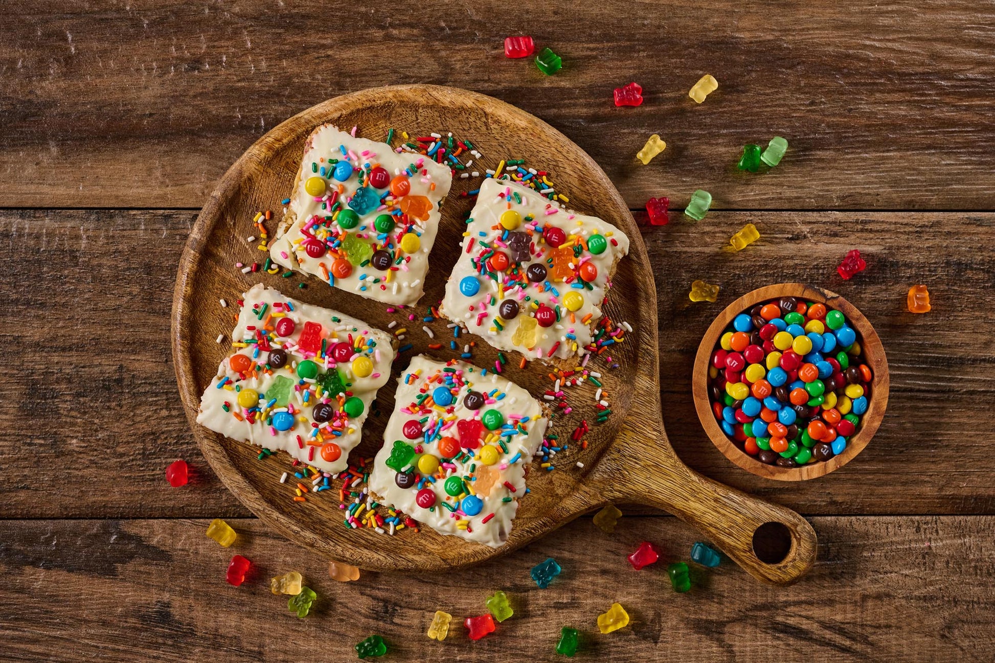 Jubilee Brownie with cake-like base, colorful rainbow sprinkles, gummy bears, and mini M&M's topping
