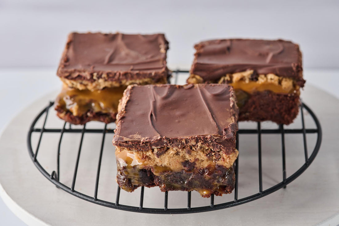 Millidough Million Dollar Cookie Dough Brownie with fudgy brownie base, caramel, homemade cookie dough, chocolate chips, and melted chocolate topping