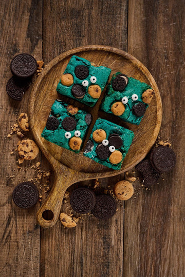 Cookie Monster Blondie with soft buttery base, chunky cookie pieces, crumbled chocolate chip cookies, and topped with Chips Ahoy, Oreo cookies, and candy eyeballs for a fun, indulgent treat