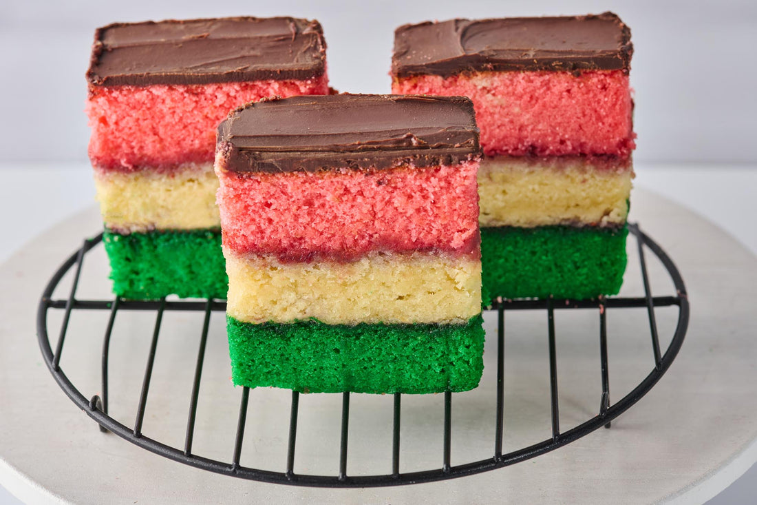 Italian Rainbow Cookie with almond cake layers, raspberry jam, chocolate coating, and colorful confetti topping