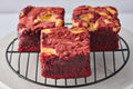 Red Velvet and Cream Cheese Brownie with a fudgy red velvet base and creamy cream cheese swirl, showcasing a rich, indulgent dessert with a vibrant color contrast and smooth texture