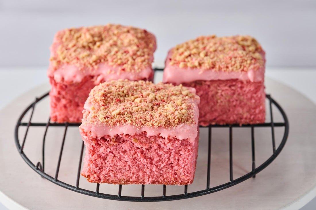 Strawberry Shortcake Blondie with freeze-dried strawberries, vanilla glaze, and golden Oreo crumbs, showcasing a soft, buttery texture and fruity, creamy layers