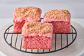 Strawberry Shortcake Blondie with freeze-dried strawberries, vanilla glaze, and golden Oreo crumbs, showcasing a soft, buttery texture and fruity, creamy layers